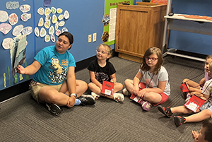 educator-reads-to-children-300x200